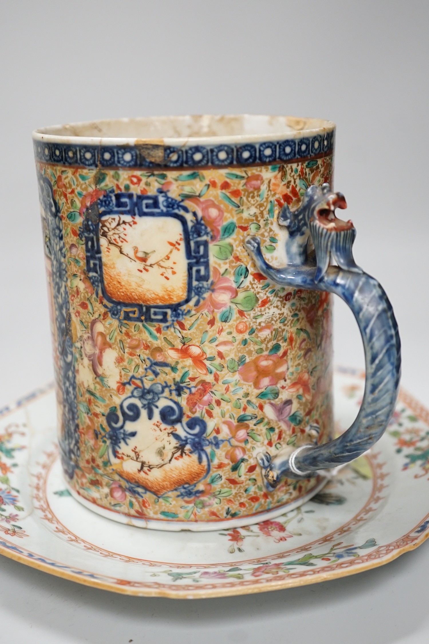 A Chinese figure of blanc de chine, a dragon tea bowl, a saucer, a large tankard, and another Chinese dish, tallest 23cm
